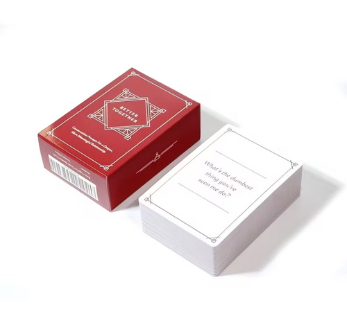 A boxed card game set on a white background, showing a red box labeled 'Better Together' and a stack of white cards with printed text.